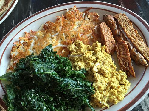 The gluten-free breakfast sampler.Wayward's signature scrambled seasoned tofu, hashbrowns, garlic steamed greens and tempeh bacon. at The Wayward Vegan in Seattle