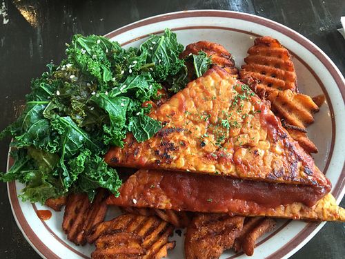 Gluten -Free BBQ Tempeh Cutlet

A grilled tempeh cutlet, basted with house-made BBQ sauce and served over smashed potatoes, and with a side of garlic steamed greens. Delicious! at The Wayward Vegan in Seattle