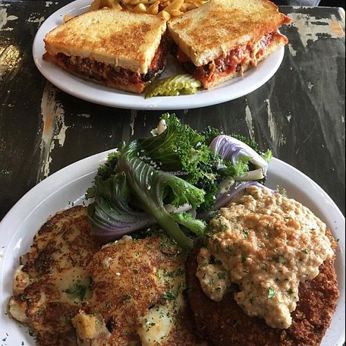 chicken parm in the back and country fried 'steak' in the front with potato cakes   at The Wayward Vegan in Seattle