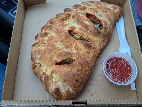 Vegan stromboli with vegan cheez, mushroom, broccoli, yellow onion, and classic Italian sauce at Glass Nickel Pizza Co. – Brookfield  in Brookfield