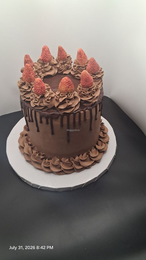 custom 6" vegan chocolate cake with strawberry curd filling,  chocolate frosting, and a chocolate ganache drip, serves 10 guests. at Plant Pastry in Jacksonville