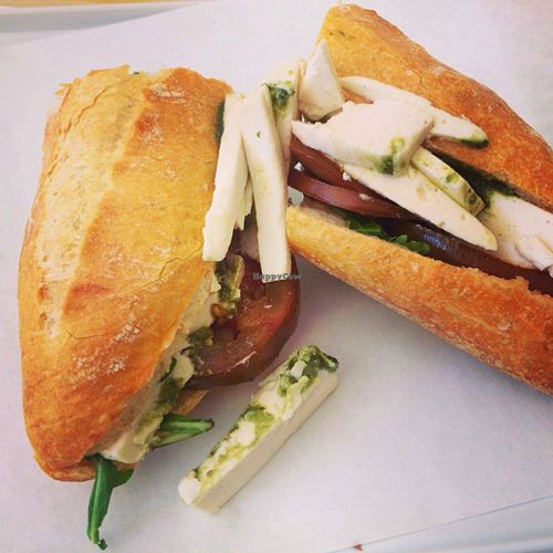 Pesto mozzarella with heirloom tomatoes and arugula on a baguette   at Vromage Dairy-Free Cheese Shop in West Hollywood