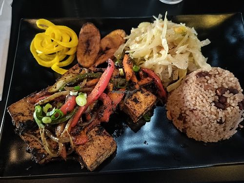 Jerk Tofu with fried plantains, cabbage, rice and peas. at Wha Gwaan Jamaica Jamaica in Tampa