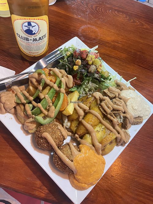 vegan mix bowl with plantain, tofu seitan, and falafel. topped with spicy peanut sauce and paired with sumac dusted fresh salad   at Kilimanjaro Wraps & Bowls in Berlin