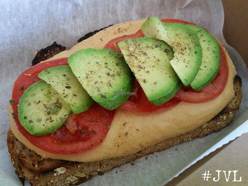 Smothered Toast...whole wheat with red pepper hummus, tomato and avacado ($2.50)  at Garden Truck in Jacksonville