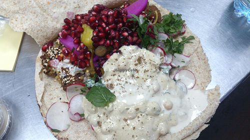 Falafel pita with vegetables, tahini sauce, hummus, pomegranate. Vegan cheese is missing in the photo. at Falafel Bejrut - Moliera in Warsaw