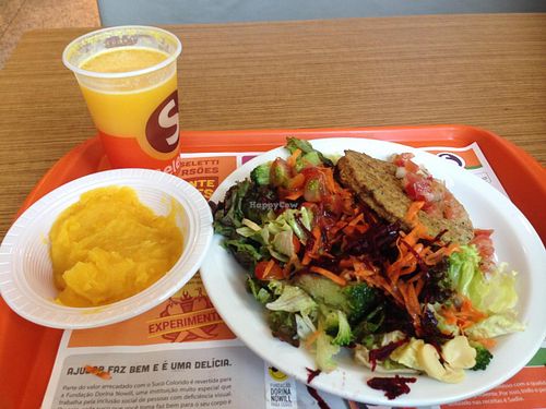 Orange juice, cassava's (mandioquica) puree, veggie burger and green salad. at Seletti - Mooca Plaza in Sao Paulo