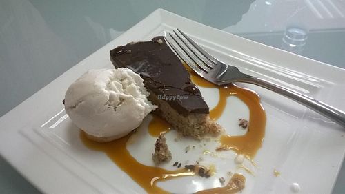 Raw vegan caramel pie with vanilla coconut ice cream. at GT Organics Cafe in Christchurch