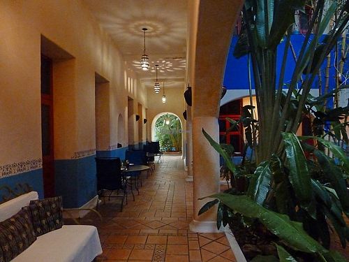 Downstairs corridor surrounding the tropical garden central patio.  at Hotel MedioMundo in Merida