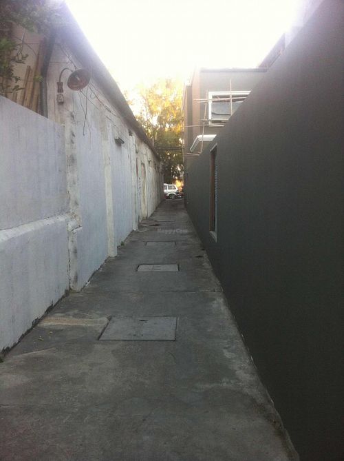 Walk down long narrow alley-way, at sign, to get to cafe at Blue Gate Cafe  in Chiang Mai