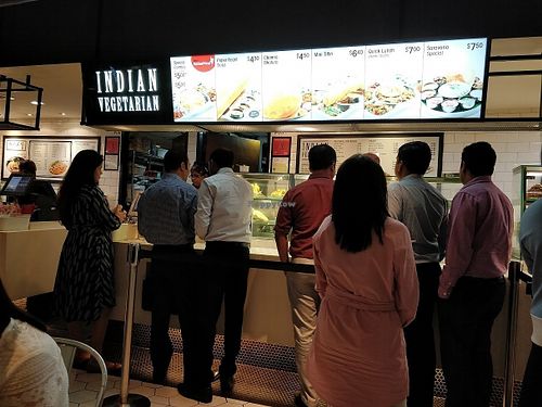lunch time crowd in front of stall  at Saravana Bhavan - Raffles Place in Central Singapore