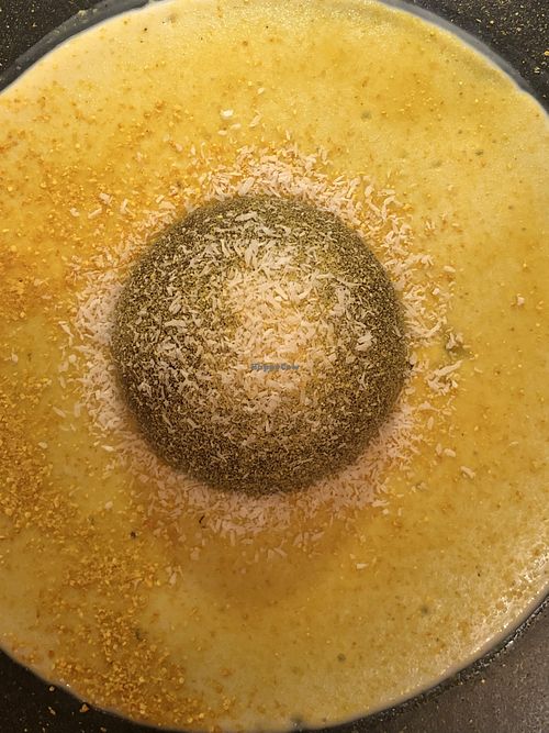 Saturno: a nutty heart in a dark chocolate semisphere and orange cream  at Al Tiglio Cucina Naturale in Moruzzo