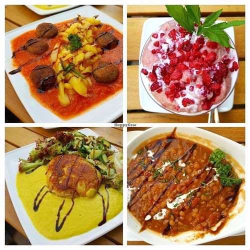 Lentil-tomato stew, tofu balls in tomato sauce, potato tortilla with turmeric sauce and wheat semolina dessert with coconut milk and raspberries. at Mariposa in Nuremberg