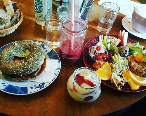 (from left to right) bread that comes with the large breakfast, sweet potato bagel, red berry smoothie, chia pudding, large breakfast at Geh Veg in Berlin