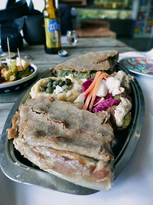 Veggie pie, fava hummus, falafel balls with tahini sauce and fermented veggies at Andriakon in Andros