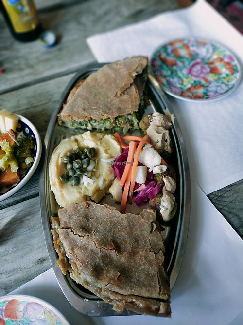 Plate of the day Veggie pie, fava hummus, falafel balls with tahini sauce and fermented veggies at Andriakon in Andros