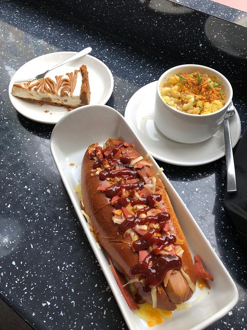 The Bourbon hot dog, side of Mac and Cheese, Biscoff Cheesecake at Vegan Antics in Gravesend