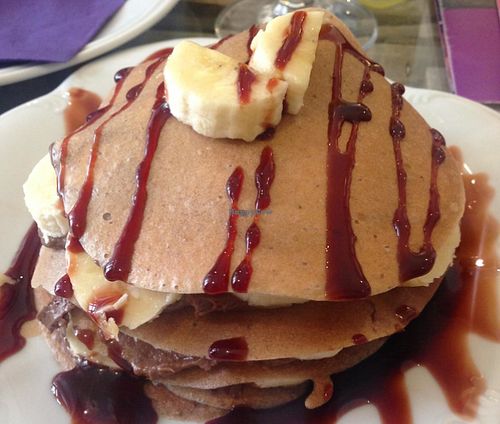 Raw pancakes with chocolate filling and sliced bananas topped with date syrup at Sweet Secret of Raw in Prague
