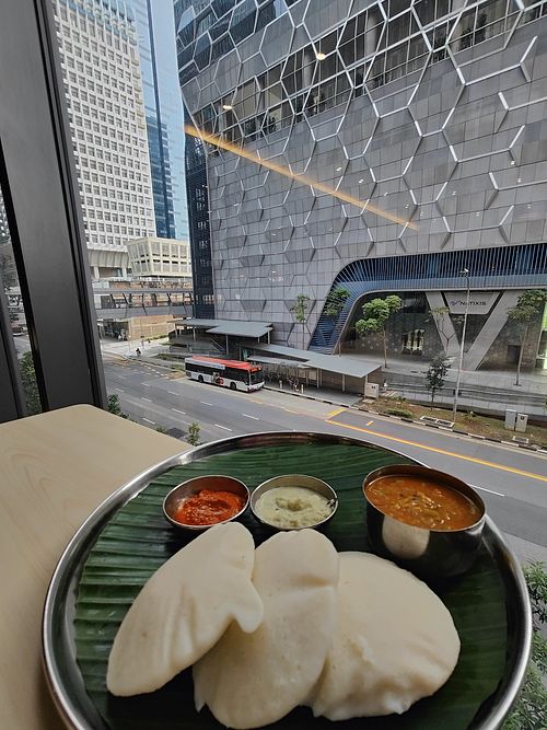 Idly and view of bus stop and UIC building at Annalakshmi Restaurant in Central Singapore