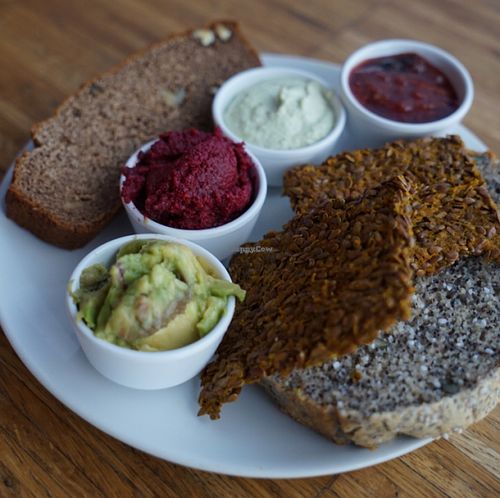 One of the Saturday breakfast options: Homemade breads: sweet loaf, raw linen seeds crackers and poppyseeds bread, all gluten-free. Homemade spreads: guacamole, beetroot pesto, macadamia cream with herbs and plum jam without sweeteners added. at Barkett in Berlin