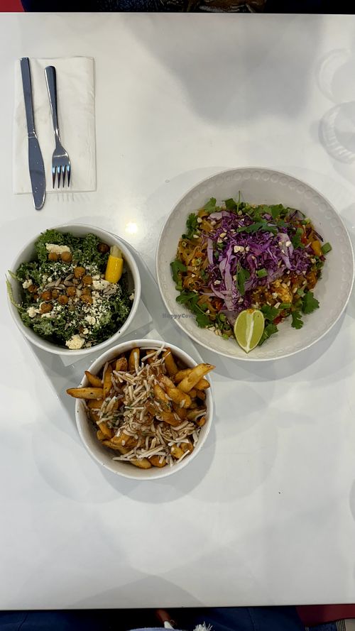 Hero shot of Pad Thai, Kale Caesar Salad and Poutine  at Naked Cafe in Kelowna
