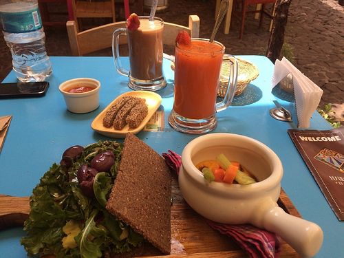 Delicious Brunch, chocolate superfood smoothie,extract 2 ,raw sandwich with raw vegan hummus and veggies. at The Green Patio in Cusco