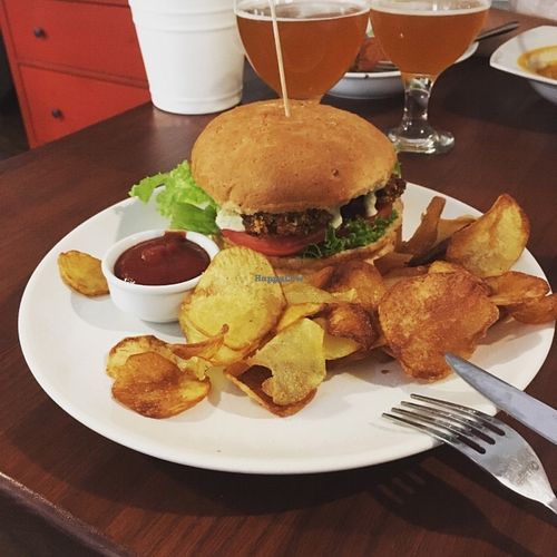 Burger with marinated soya nuggets, served with potato chips and spicy tomato sauce.  Delicious dish , was perfect because not dry. at GYVAS baras in Vilnius