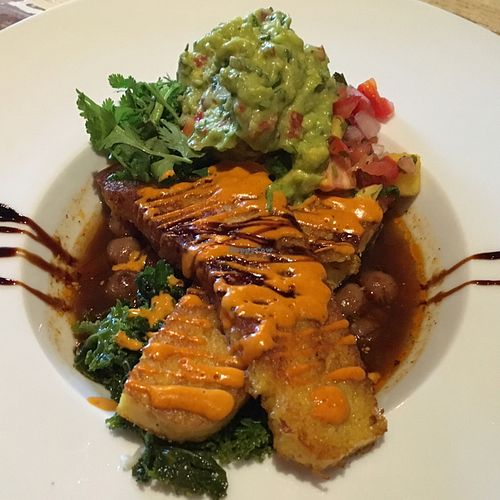 Saffron-infused pan-seared savory corn cake with guacamole. Incredible dish.  at Vegetable in Studio City