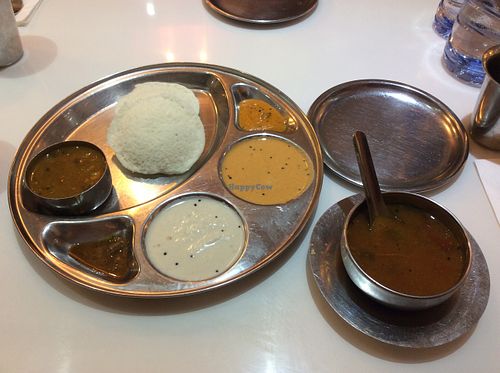 A dish that is deemed an appetizer or starter. Steamed flat buns and sauces for dipping. Stew on the side. at Saravana Bhavan in Kowloon