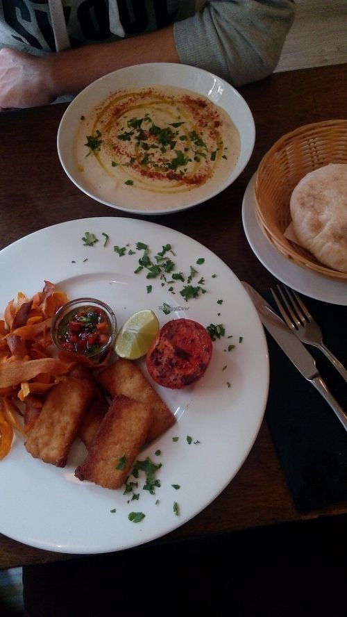 2nd course for two from the lunch menu - fried tofu slices with lime, roasted veggies, dressing of olive oil, herbs and pepper paired with sweet potato chips and a hummus dish, accompanied by pita bread at Hummus in Barcelona