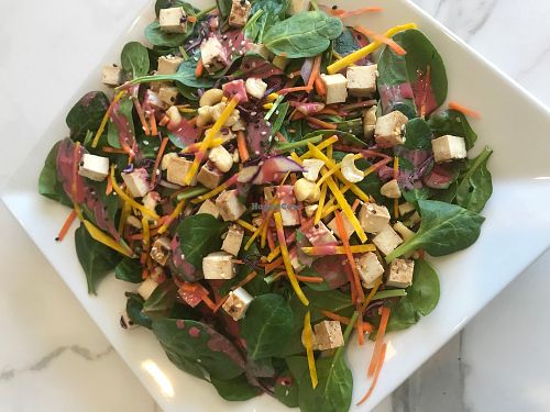 Spinach and Marinated Tofu Salad.   This protein packed salad comes with our homemade beet and coconut vinegar dressing.  A hearty portion that will not only fill you up, but will keep you going long after you are done. at LOVJuice in Boca Raton