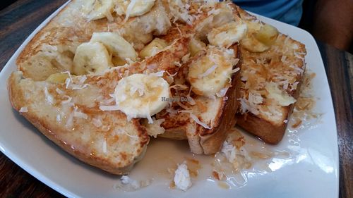 Vegan French Toast with bananas, toasted coconut, and coconut syrup. Amazing! Best I've ever had! at Mesa Cafe in San Pedro