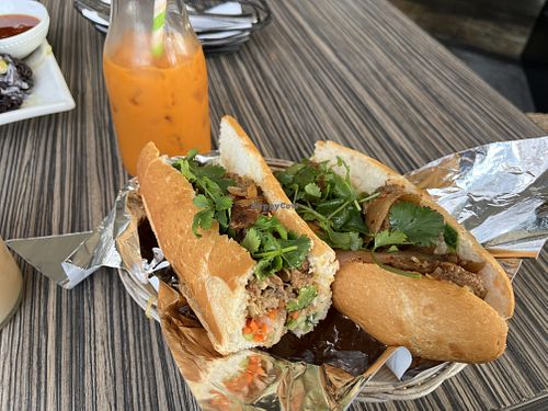 Lemongrass beef banh mi with a Thai iced tea in the background  at The Purple Mint - El Cajon Blvd in San Diego