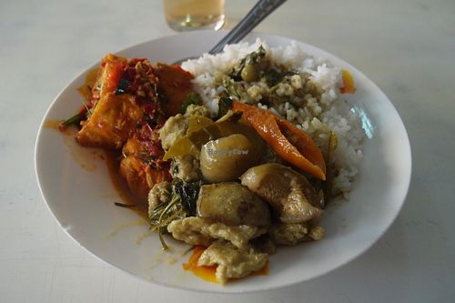 A delicious plate of rice with some very fresh fried tofu in tomato sauce and vegetarian thai green curry.  at Raan Tang Lieng Soon in Sri Racha
