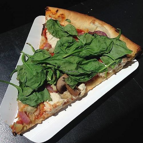 'Reunion Tour' - local organic tomato sauce, marinated mushrooms, garlic artichokes, red onions, cherry tomatoes, baby spinach and cashew ricotta cheese. at Apiecalypse Now Pizza and Snack Bar in Toronto