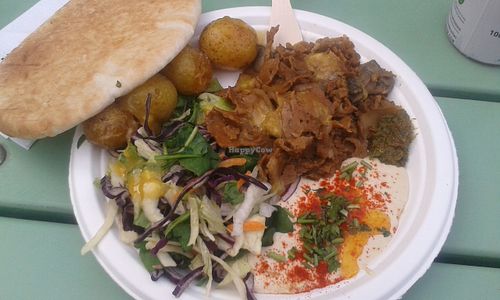 Seitan plate with fresh self baked bread, potatoes, salad and mango sauce at Schmegan - Food Truck in Stockholm