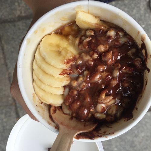 mixed up porridge with chocolate, banana and maple syrup  at Haferkater in Berlin