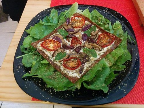 An excellent raw pizza of different seeds with dry tomatoes, kashew cheese and rúcula. at La Chakra in Lima