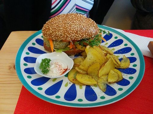 Two different small burgers in a seed bread with potatoes and vegan mayonnaise. at La Chakra in Lima