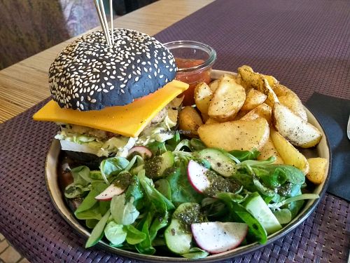 The side salad here was as tasty as the burger: fresh and light, ideal to go with the nice chunky potatoes and the savoury burger. at Bhajan Cafe in Riga