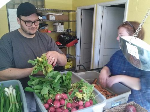 Chef Dustin buying produce direct from Sprout Urban Farms in Battle Creek. at Rabbit Patch Vegan Snacks - Food Stall in Battle Creek