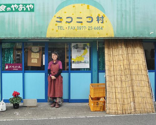 The owner, Michiko-san, posing in fron to the shop. Credit: beppueats.wordpress.com at Niconicomura Organic Vegan Food in Beppu