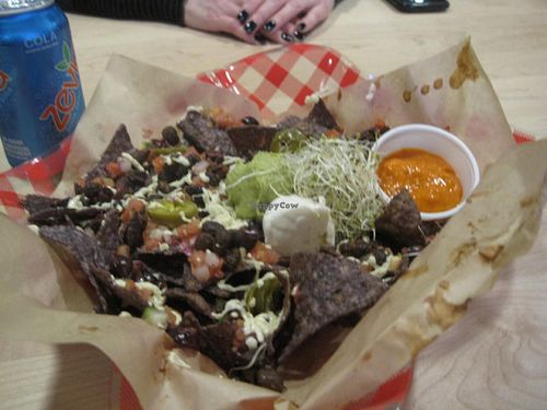 Nachos : freshly oven-baked organic tortillas, topped with melted Daiya cheese, guacamole, sour cream, fresh bruschetta, marinated jalapenos, and Copper Branch's signature mango pineapple habanero hot sauce.

Really good, and the sauce is extreme. at Copper Branch - 600 Maisonneuve W/O in Montreal