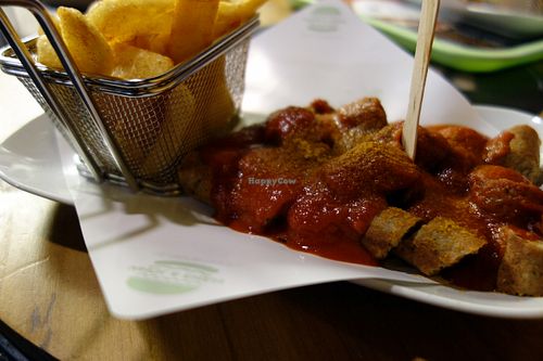 Vegan tofu sausage in curry sauce with chips 'Currywurst mit Pommes' at Hans und John  in Schwerin