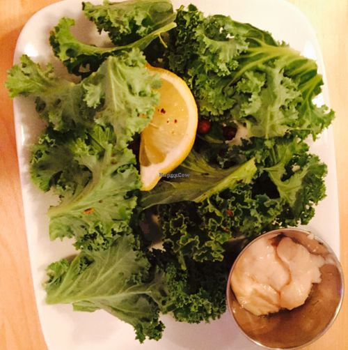 kale salad appetizer with dressing on the side  at Le Soixante 5 in Levis