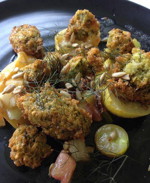 Sample vegan entree - lemon squash with sorrel falafel crumble, marinated tomato, sunflower kernels, and lemon balm. at The Restaurant at Patowmack Farm in Lovettsville