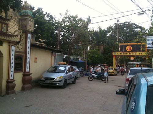 Entrance of the alley as seen from the pagoda. Try to spot this big red banner from the main street. at Chua Due Tu in Hanoi