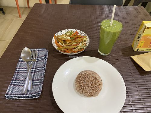 Fried veggies with rice and green smoothie   at Wellnessland Vegetarian Cafe in Cebu
