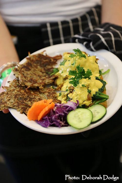 Eggolicious - two pan fried millet patties with sauteed spinach, poached eggs OR tofu scramble and a cashew creme sauce with a little kick to top it off. Yum! at 7th Element in Burbank