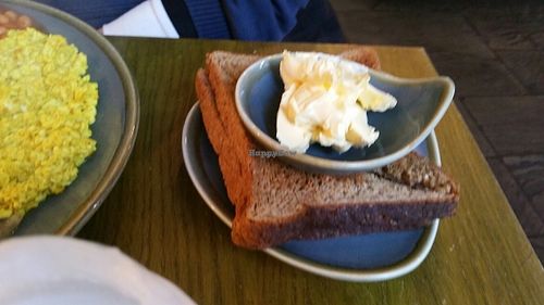 Side of toast and vegan butter with big breakfast  at Vegan Hippo in London